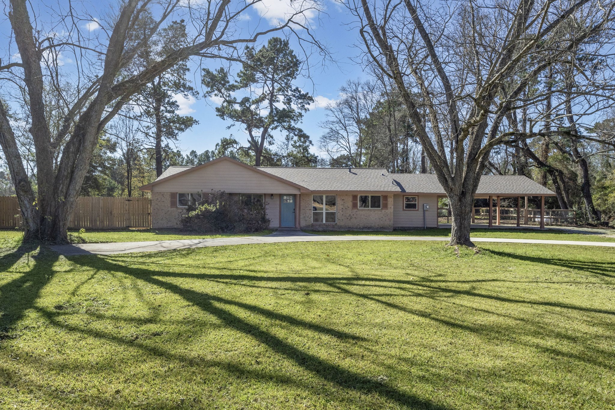 44271 Highway 105 Hull, TX 77564 - Photo 2 of 38 a front view of house with yard and trees