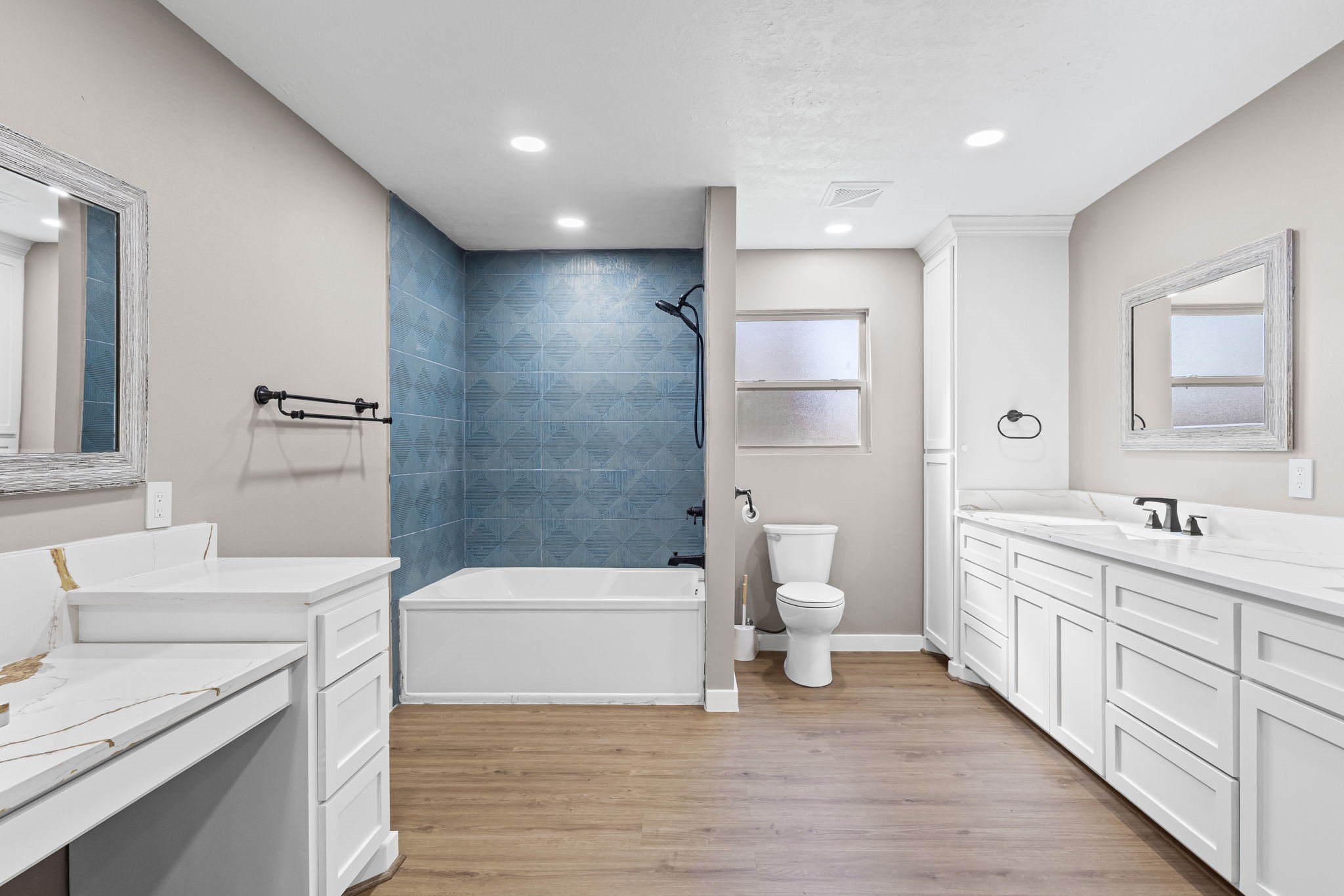 44271 Highway 105 Hull, TX 77564 - Photo 21 of 38 a bathroom with a double vanity sink a toilet and a tub