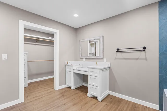 a room with a bench and a hallway