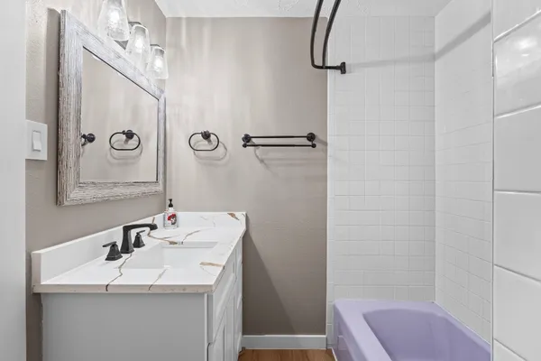 a bathroom with a sink a toilet a shower and a mirror