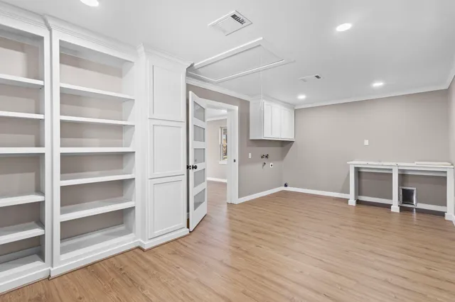 a view of a kitchen with wooden floor and a window