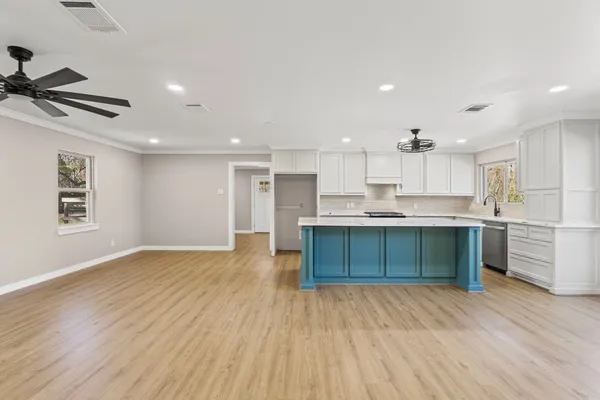 a kitchen with a refrigerator and a stove top oven