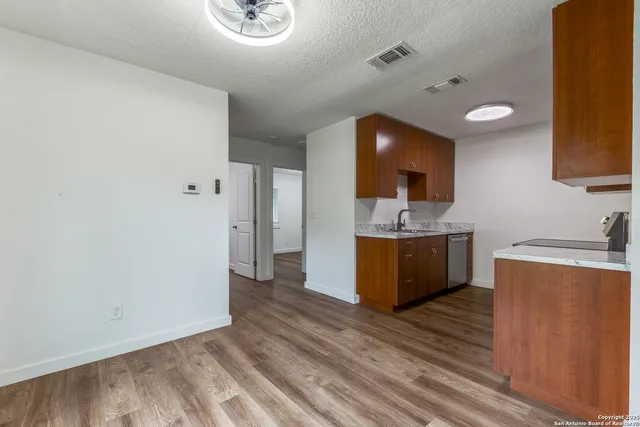 a view of a kitchen with a sink and a refrigerator