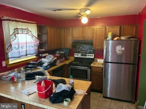 a kitchen with a refrigerator and a stove