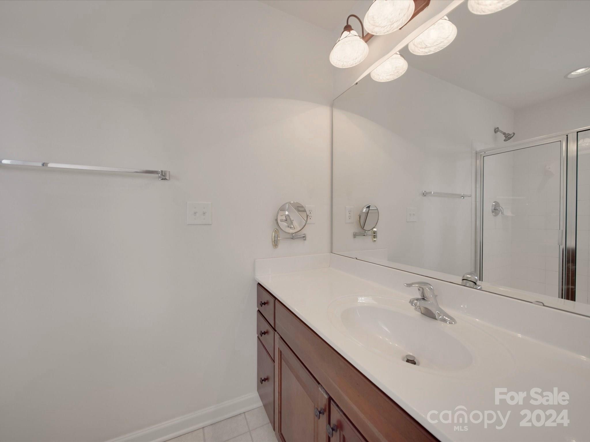 1004 Spanish Moss Road Indian Trail, NC 28079 - Photo 23 of 25 a bathroom with a sink and a mirror