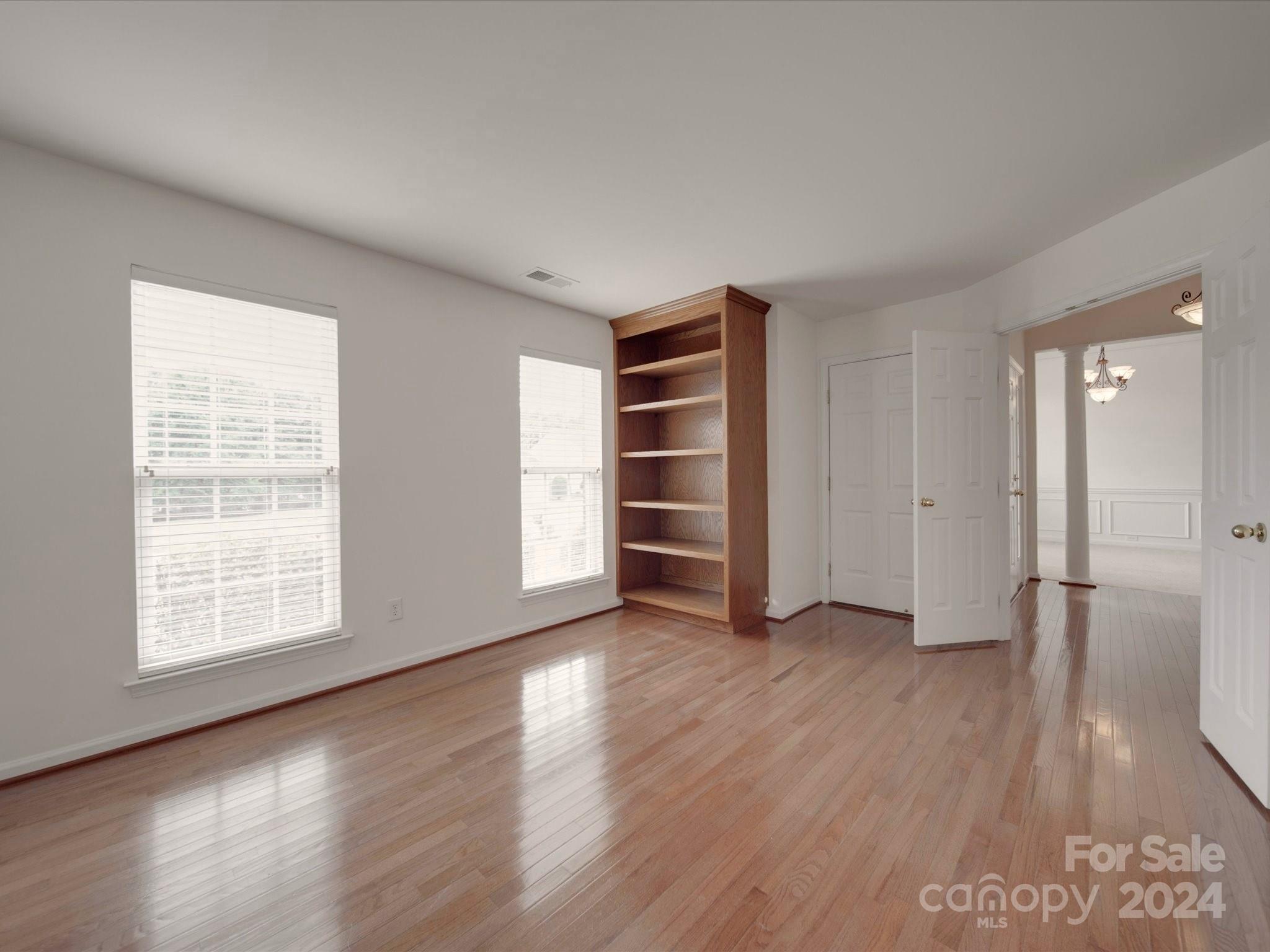 1004 Spanish Moss Road Indian Trail, NC 28079 - Photo 3 of 25 an empty room with wooden floor closet and windows