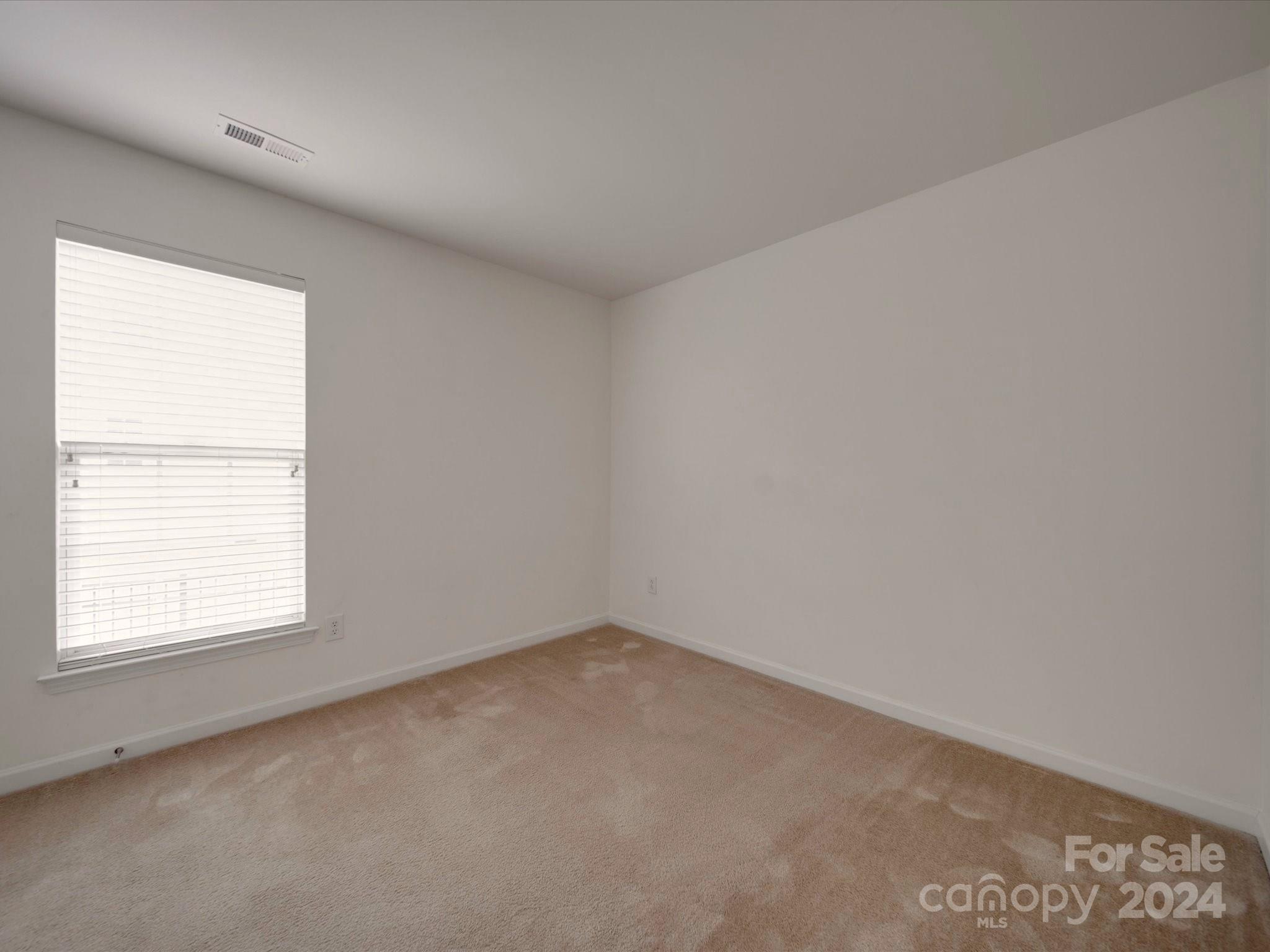 1004 Spanish Moss Road Indian Trail, NC 28079 - Photo 4 of 25 an empty room with a window