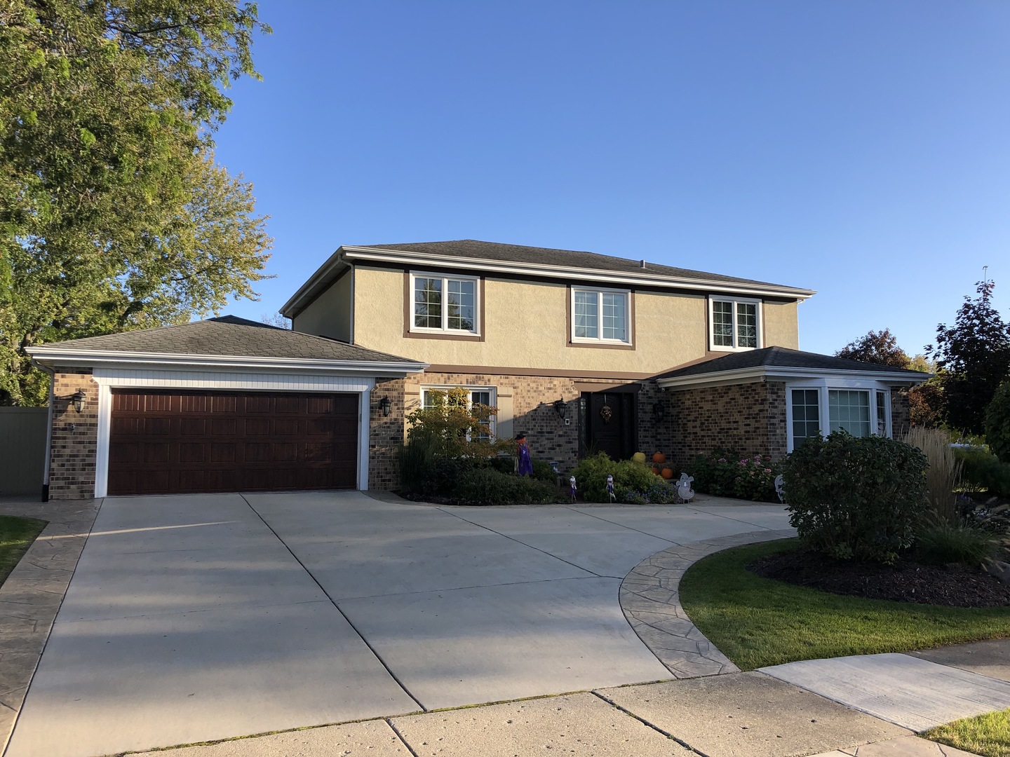 a front view of a house with a yard and a garage