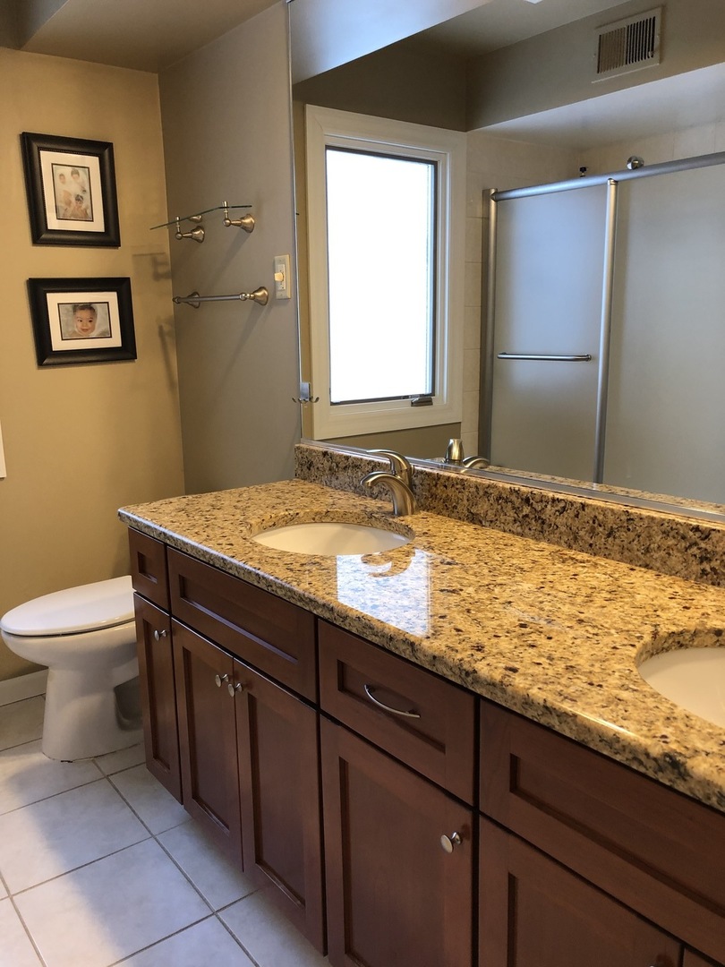 3324 Lake Knoll Drive Northbrook, IL 60062 - Photo 17 of 27 a bathroom with a granite countertop sink and a toilet