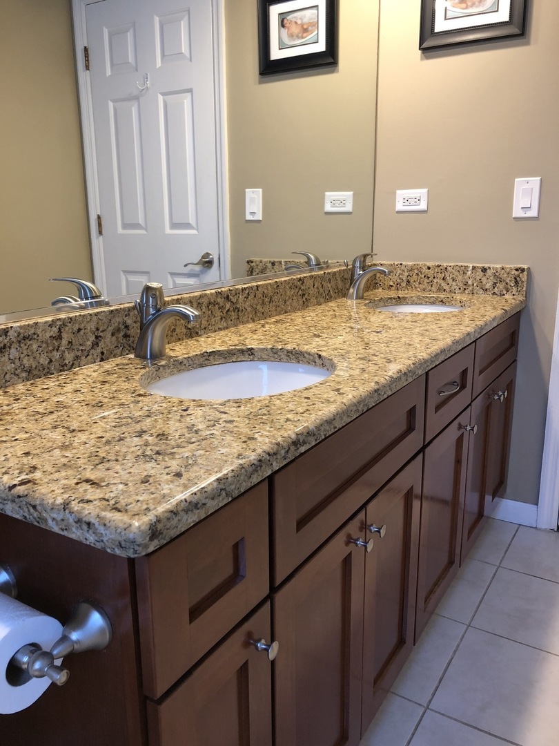 3324 Lake Knoll Drive Northbrook, IL 60062 - Photo 18 of 27 a bathroom with a granite countertop sink and a mirror