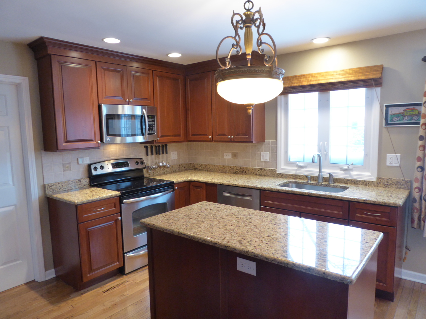 3324 Lake Knoll Drive Northbrook, IL 60062 - Photo 9 of 27 a kitchen with stainless steel appliances granite countertop a sink stove and microwave