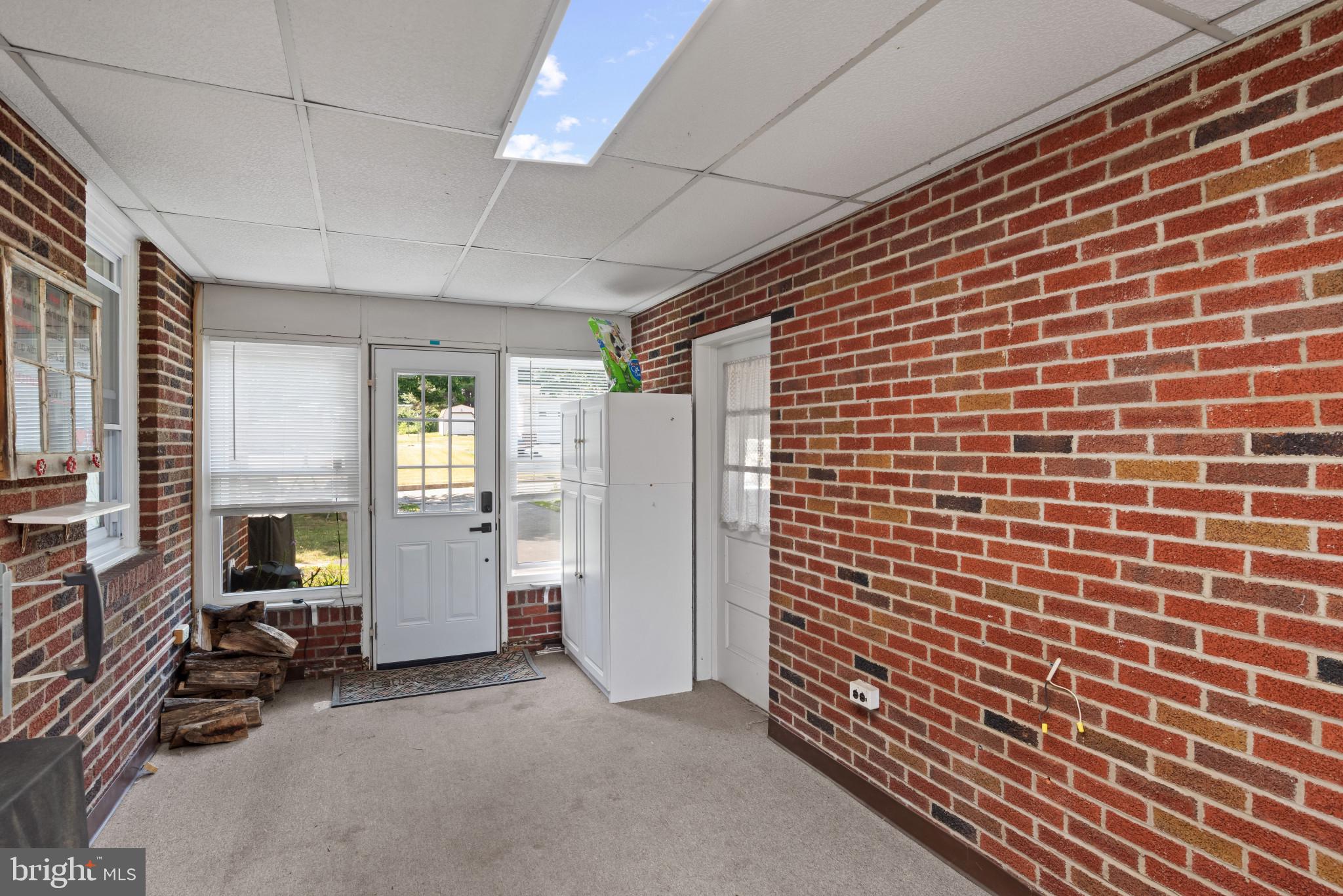 14 Sharon Road Enola, PA 17025 - Photo 29 of 40 Enclosed sunroom featuring exposed brick walls, a