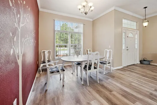 a kitchen with stainless steel appliances granite countertop a sink cabinets and wooden floor