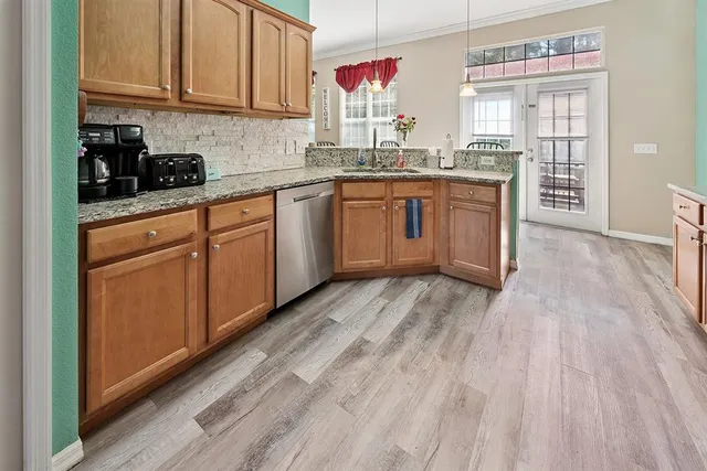 a kitchen with stainless steel appliances granite countertop a stove a sink and a refrigerator