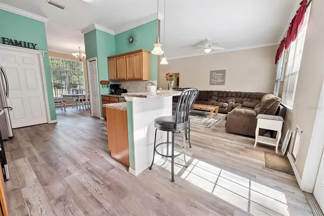 a spacious bedroom with a bed and a chandelier