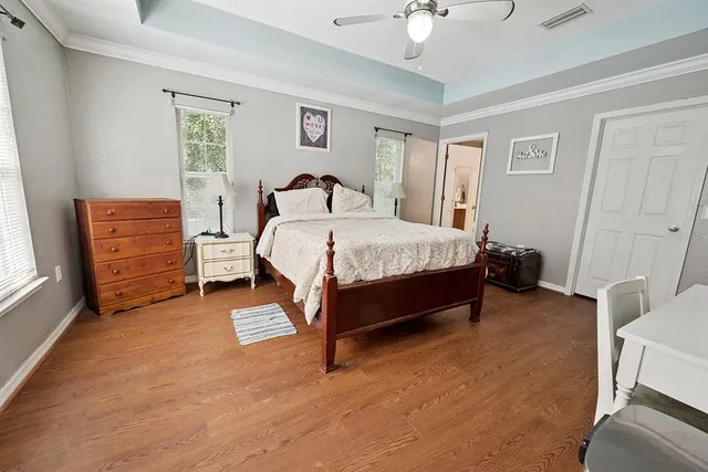 a bathroom with a granite countertop sink a mirror and shower