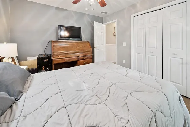 a view of a patio with table and chairs a barbeque with wooden floor and roof with a garden view