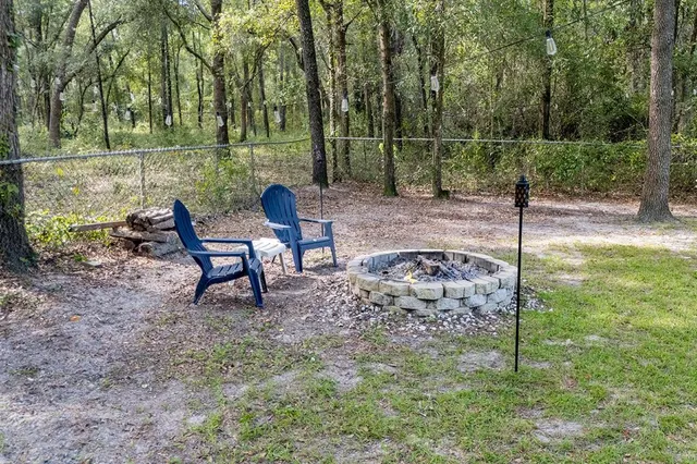 a view of a deck with table and chairs with wooden floor and floor to ceiling window