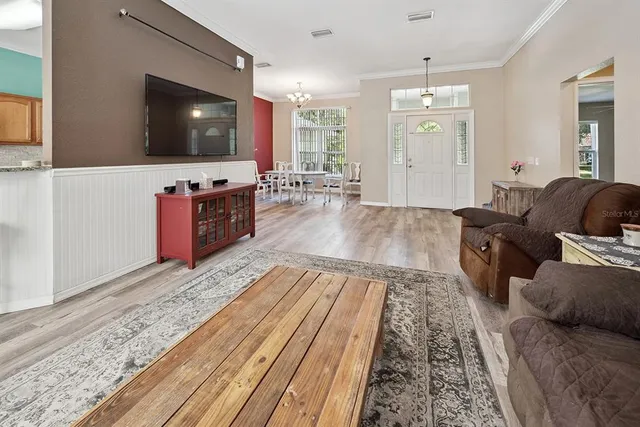 a view of a dining room with furniture window and wooden floor