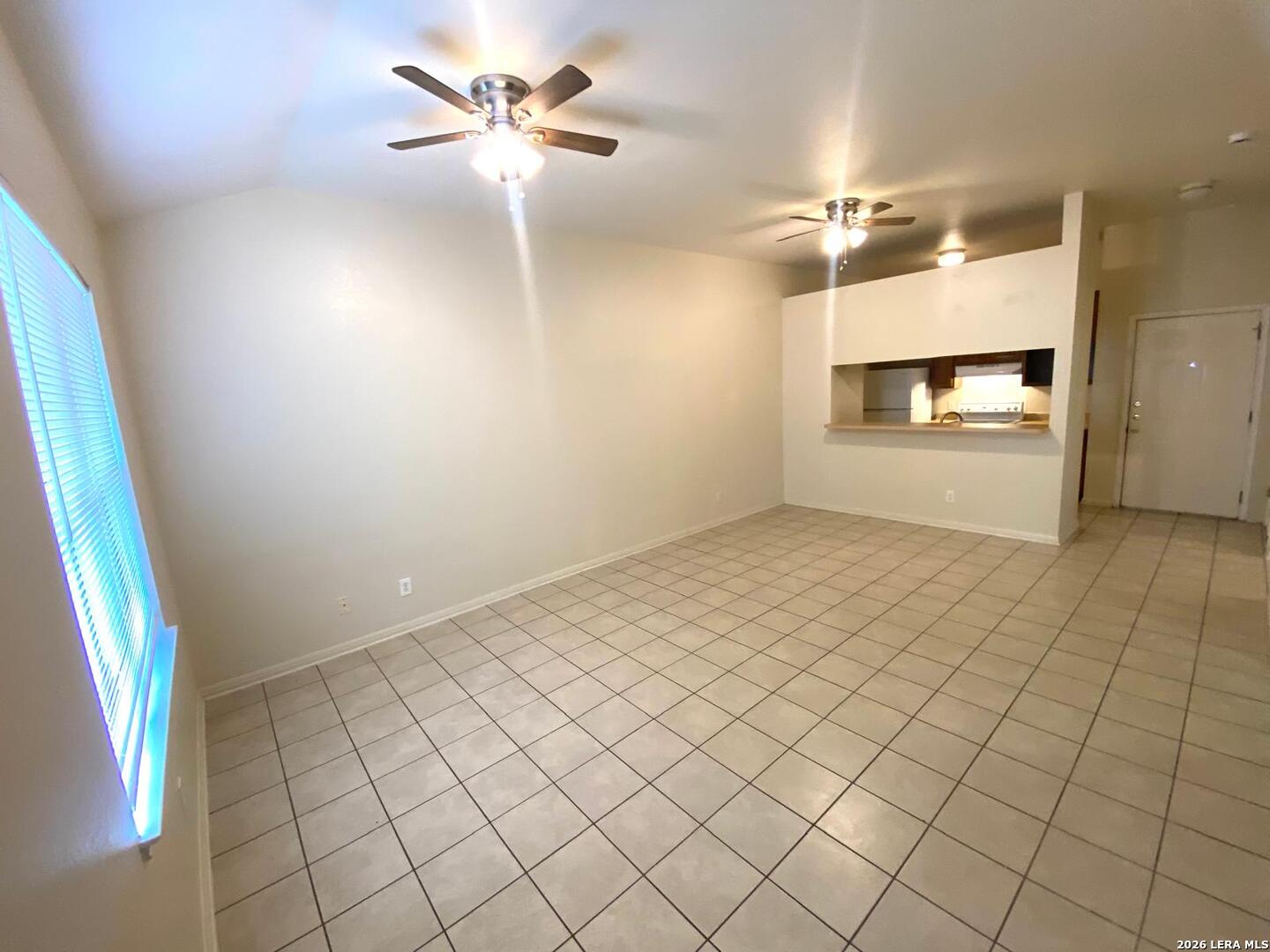 506 Dukeway, Unit 3 Universal City, TX 78148 - Photo 6 of 16 a view of a room with a ceiling fan and window