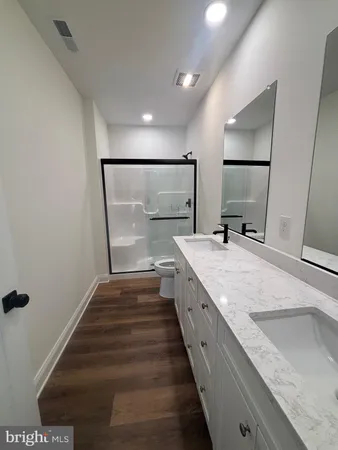 a large kitchen with a sink and a large mirror