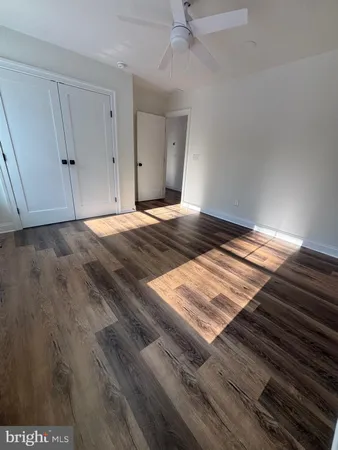 a view of a room with wooden floor