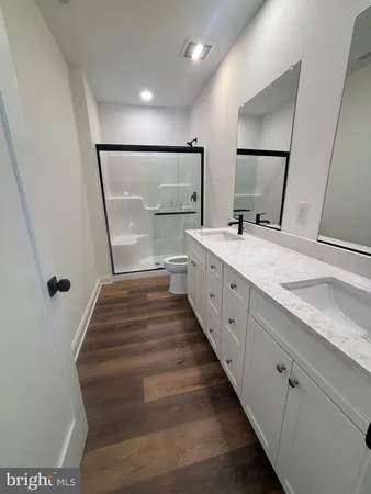 a bathroom with a double vanity sink and mirror