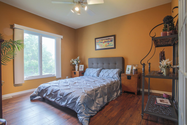 2635 Saltmeadow Road Naperville, IL 60564 - Photo 8 of 25 a bedroom with a bed and wooden floor
