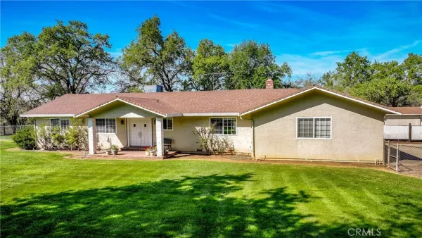 a kitchen with white cabinets and sink