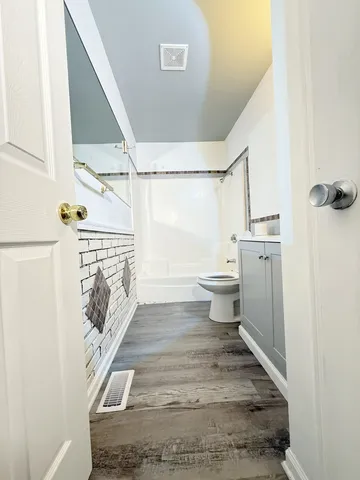 a bathroom with a toilet and a shower