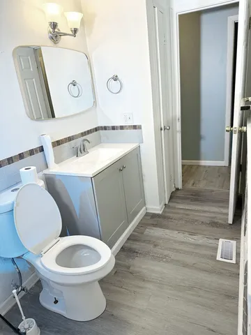 a white toilet sitting next to a bathroom sink