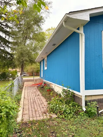 a view of an house with backyard space and balcony