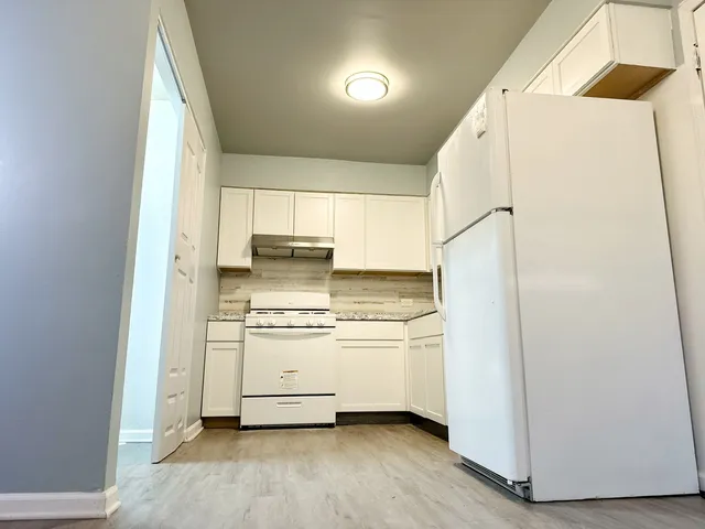 a kitchen with stainless steel appliances a refrigerator and a stove