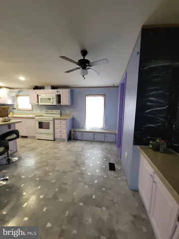 a large kitchen with stainless steel appliances a stove and a refrigerator