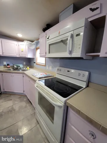 a kitchen with stainless steel appliances a stove microwave and cabinets