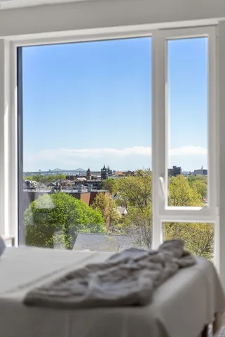 a bed sitting in a bedroom next to a window