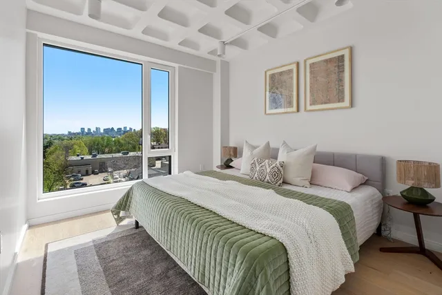 a bedroom with a large bed and a window