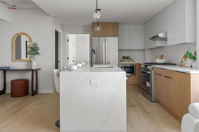 a utility room with cabinets washer and dryer