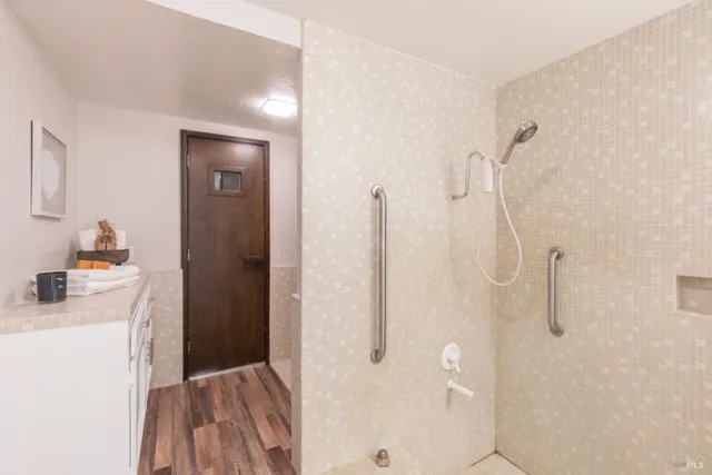 a bathroom with a sink a toilet and shower