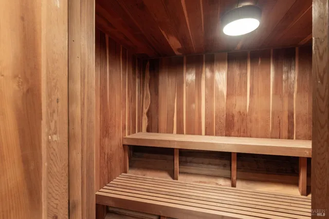 a view of an empty room with wooden floor and closet