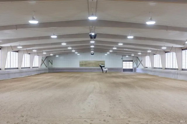 a view of a hallway to a livingroom with furniture