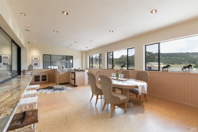 a room with furniture pool table and chairs