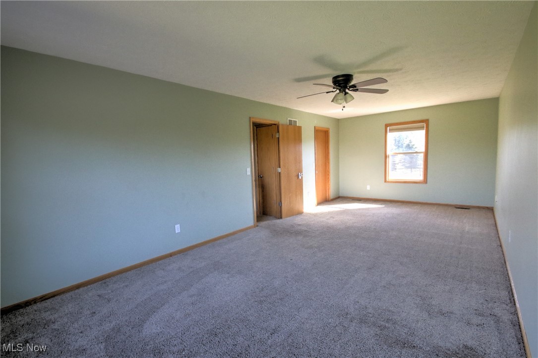 4998 Wayne Road Mantua, OH 44255 - Photo 28 of 43 Upstairs large bedroom featuring light carpet and ceiling fan