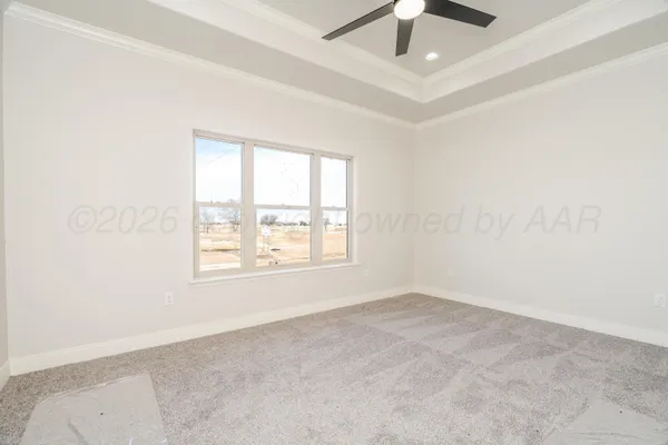 an empty room with a window and a ceiling fan