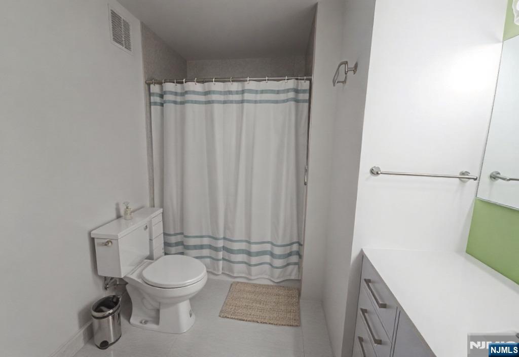 50 Euclid Avenue, Unit 3B Hackensack, NJ 07601 - Photo 9 of 16 a bathroom with a toilet and a sink