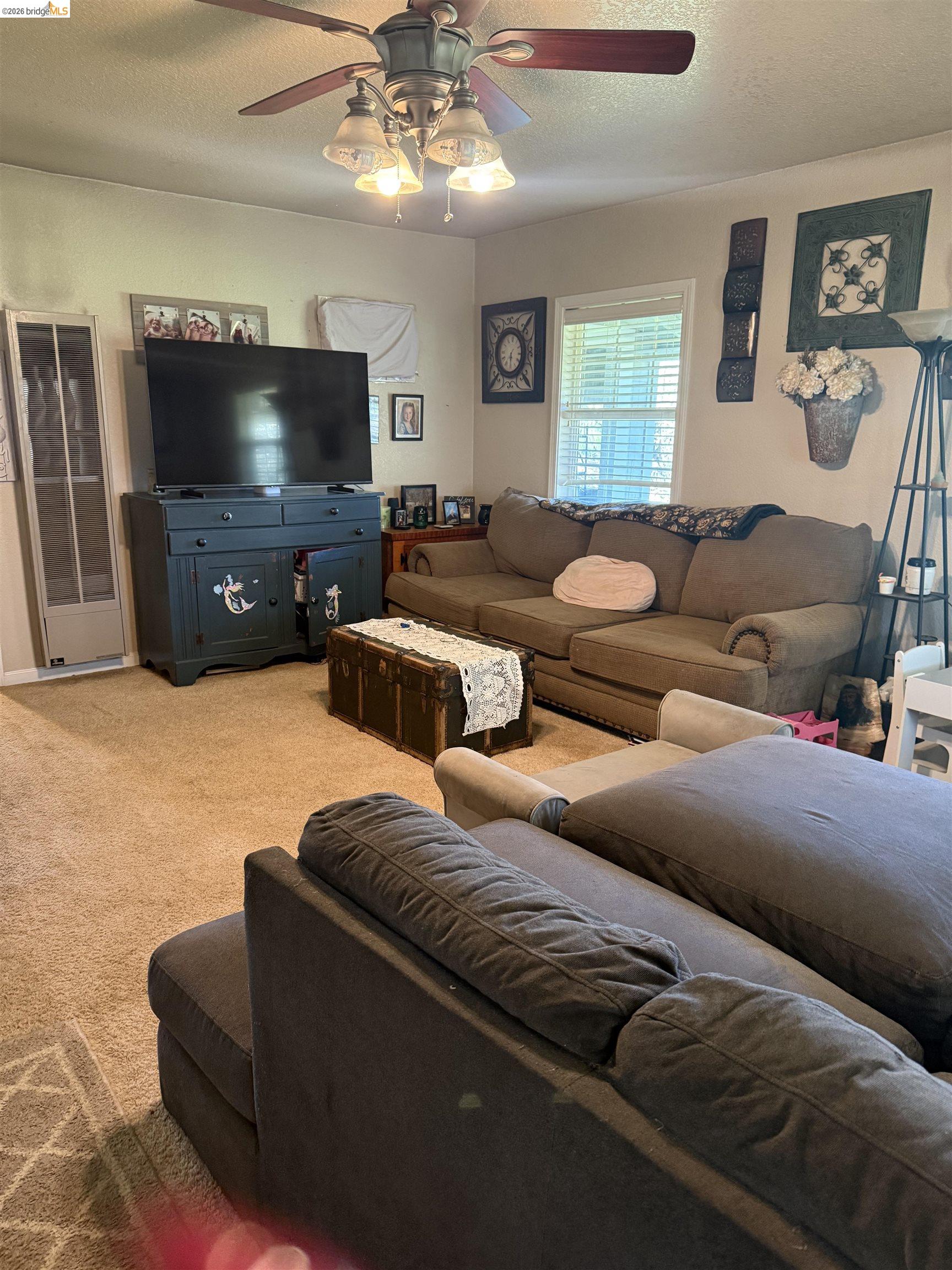 9436 Fraguero Road Sonora, CA 95370 - Photo 18 of 18 a living room with furniture and a flat screen tv