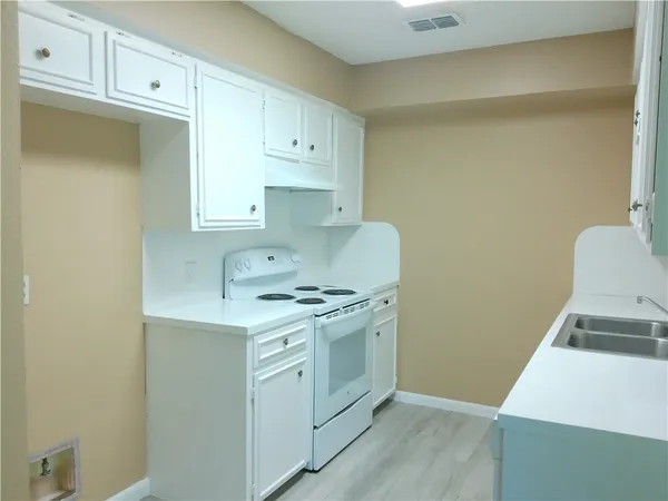 a kitchen with a stove and a sink