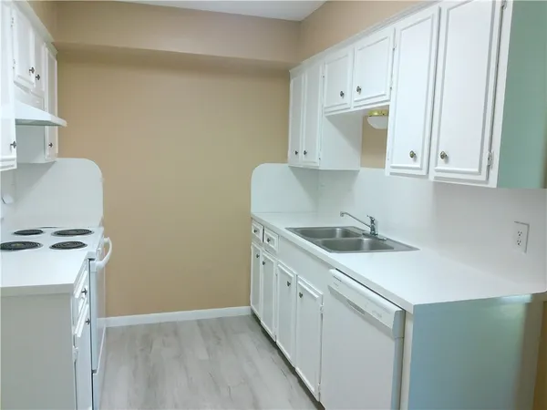 a kitchen with a sink cabinets and appliances