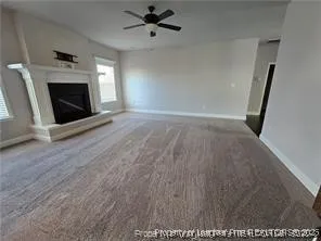 a view of an empty room with a fireplace and a window