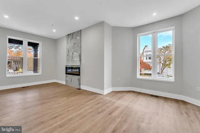 a kitchen with stainless steel appliances granite countertop a refrigerator a stove microwave and cabinets